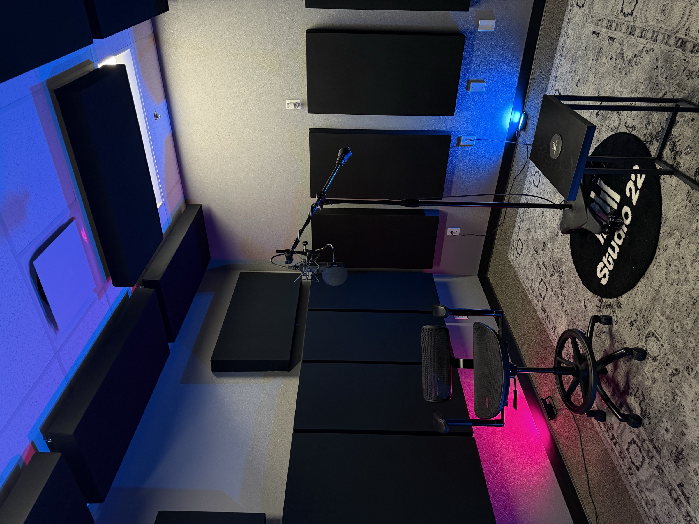 Studio 22 recording room with acoustic treatment, microphone stand, and artist seating