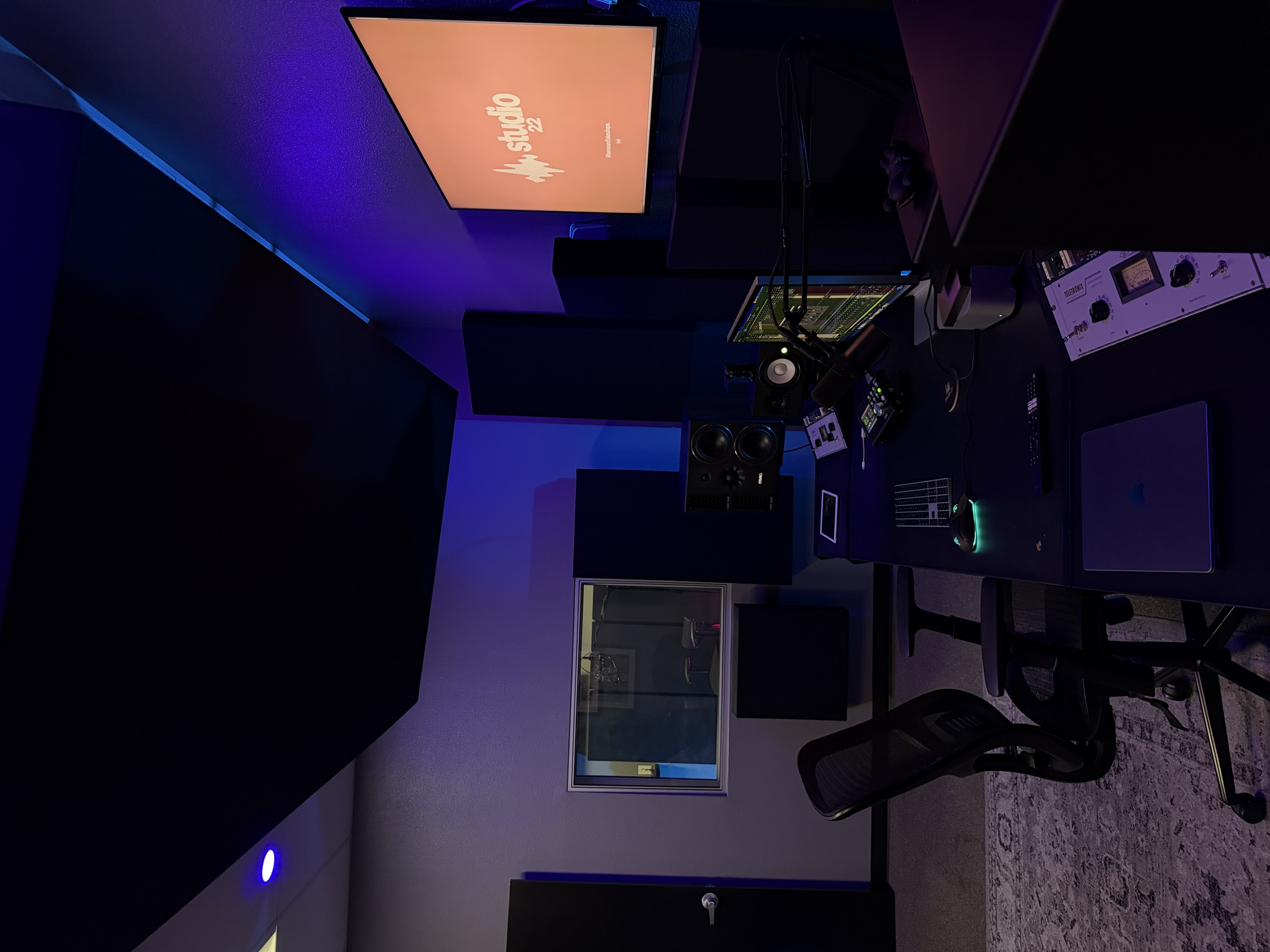 Side view of the Studio 22 control room, desk, and acoustic treatment